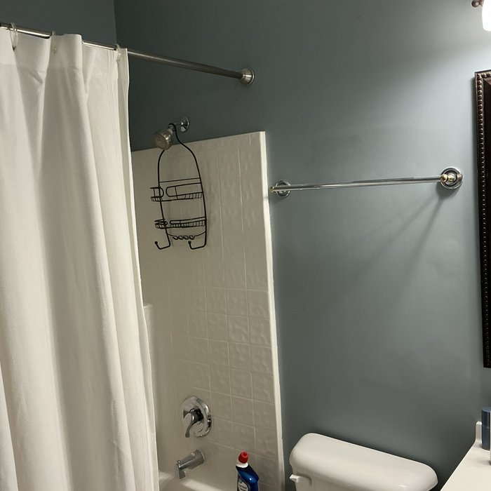 Bathroom wall before repair, with a bubbling patch
